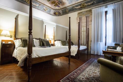 a bedroom with two beds and a ceiling at Hotel Burchianti in Florence