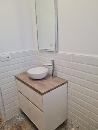 a bathroom with a white sink and a mirror at Relaxing & Cozy House in Gran Alacant