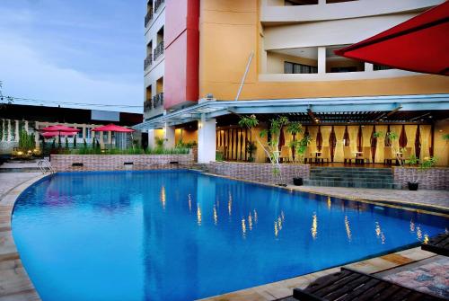 a large swimming pool in front of a building at ASTON Pontianak Hotel and Convention Center in Pontianak