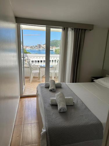 a bedroom with a bed with two towels on it at Apartments Villa Simoni in Split