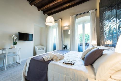 a bedroom with a large bed and a desk at LuxurYenne in Cagliari