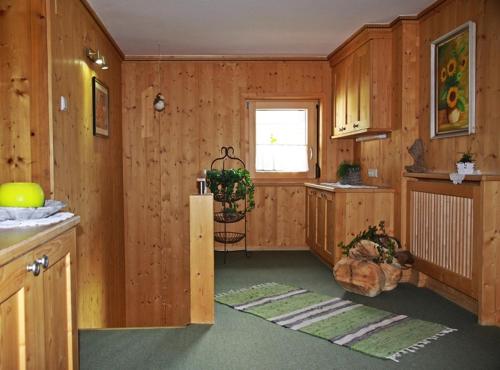 a kitchen with wood paneled walls and a window at Landhaus Hubert Fiegl in Sölden