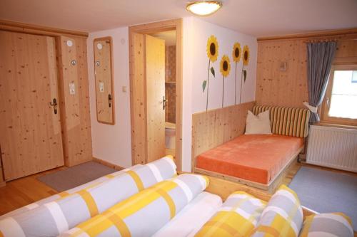 a living room with a couch and a bed at Landhaus Hubert Fiegl in Sölden