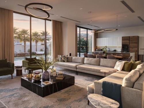 a living room with a couch and a table at Villa 72 RAK in Ras al Khaimah