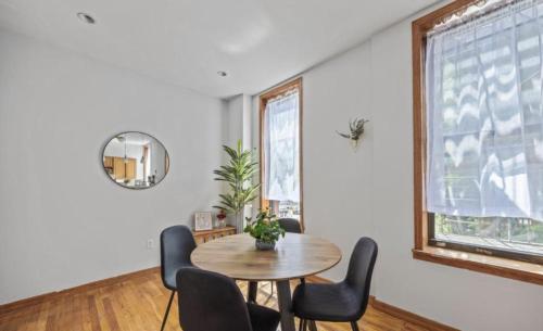 a dining room with a table and chairs and a mirror at The NYC Value Room near Times Square & Broadway - Private Room with shared bathroom in New York