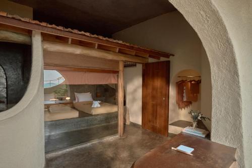 a bedroom with a bed and a table in a room at Ibala Hotel & Spa in Nha Trang