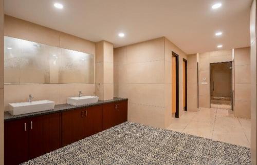 a large bathroom with two sinks and a shower at Oshana Stays,Fully furnished Studio Apartment with Pool,Sauna,Siolim, Goa in Mapusa