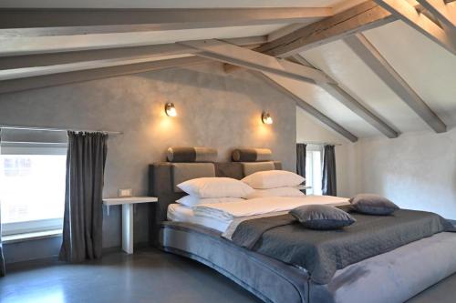 a bedroom with a large bed in a attic at San Mauro rooms in Poreč