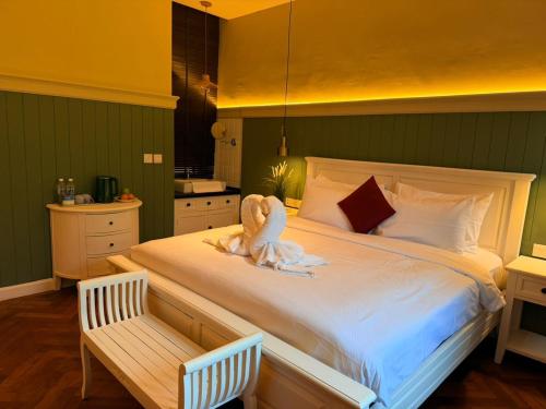 a bedroom with a bed with a stuffed animal on it at The Chambers Georgetown in George Town