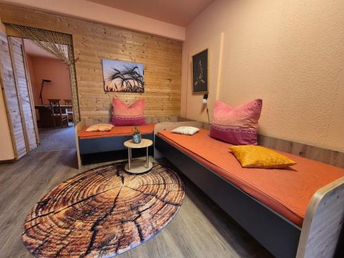 a room with two beds and a circular rug at Apartments Schramm in Eisenach