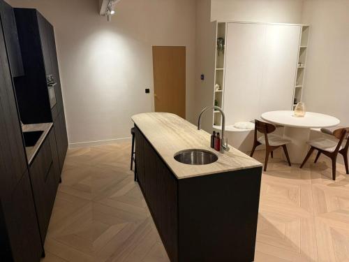 a bathroom with a sink in the middle of a room at Duin & Zee in Ostend