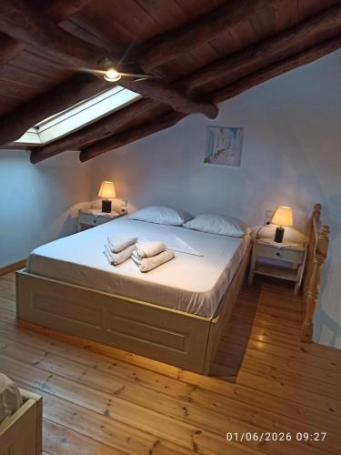 a bedroom with a large bed with towels on it at Skiathos island house in Skiathos