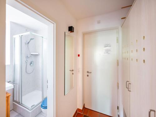 a bathroom with a shower and a glass door at Feriendorf Rugana - Klassik 1-Raum Ferienwohnung mit Terrasse B59 in Dranske