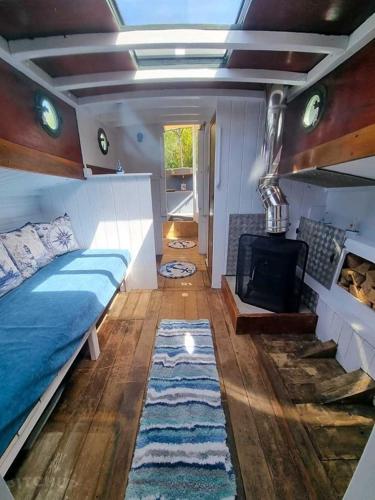 a bedroom with a bed and a fireplace at The Ship Aground Woolacombe in Woolacombe