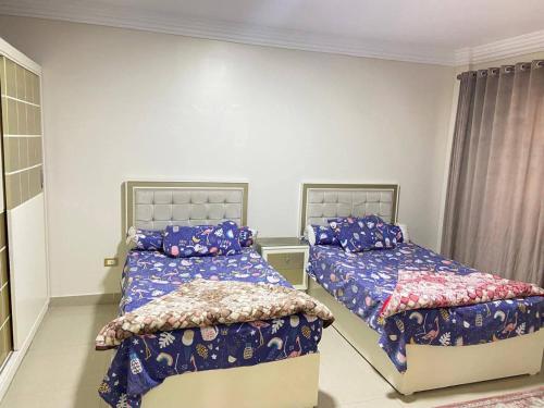 a bedroom with two beds in a room at Vera home in Kafr al Ishārah