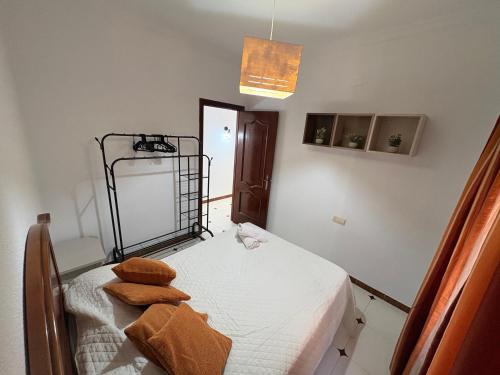 a bedroom with a bed with brown pillows on it at Bulevar Carlos III in La Carlota