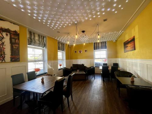 a dining room with a table and chairs at The Harbour Hotel in Greenock