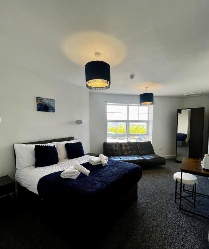 a living room with a bed and a couch at The Harbour Hotel in Greenock