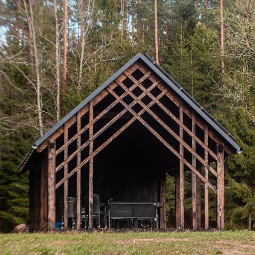 a large wooden barn in the middle of a forest at refleXions in Kabakelis