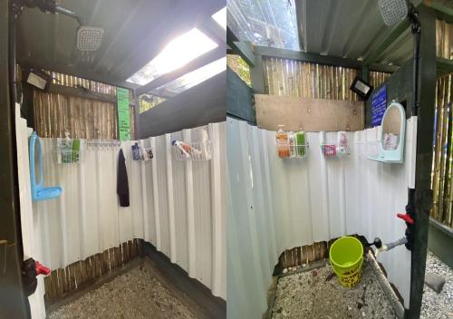 a bathroom with white shower curtains and a bucket at One Ocean Nature Conservation Centre in Kota Belud
