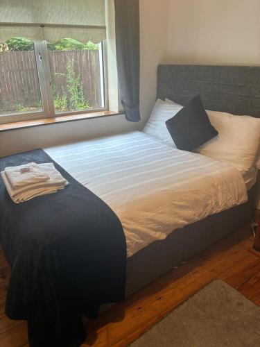a bedroom with a large bed with a window at Ríocht Fódla 2 in Killarney