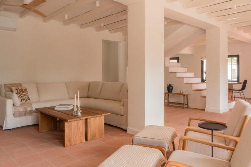a living room with a couch and a table at Finca La Oliveta Ronda in Ronda