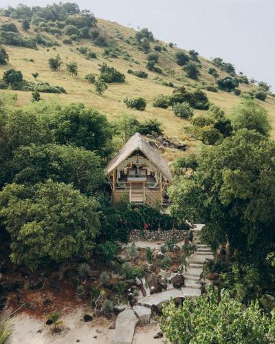 a small cabin on the side of a hill at Le Pirate Island - Adults Only in Labuan Bajo