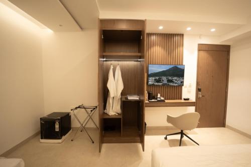 a room with a desk and a chair in a room at Sawariya Hotels in Tiruvannāmalai