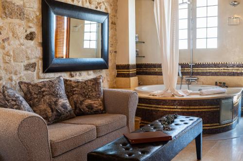 a living room with a couch and a bath tub at Avli Lounge Apartments in Rethymno