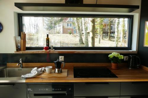 a kitchen with a sink and a large window at Bosco Due in Łagów