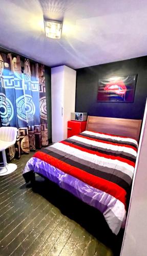 a bedroom with a bed with a red white and black stripes at Luxury KIA Room D in Richmond Hill