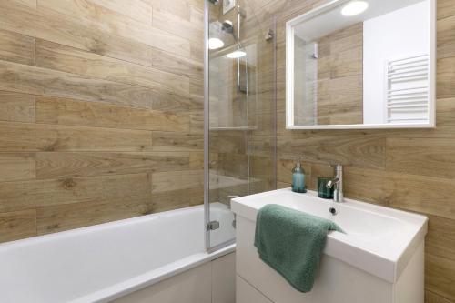 a bathroom with a white sink and a shower at Les Cimes - La Canopée in Gresse-en-Vercors