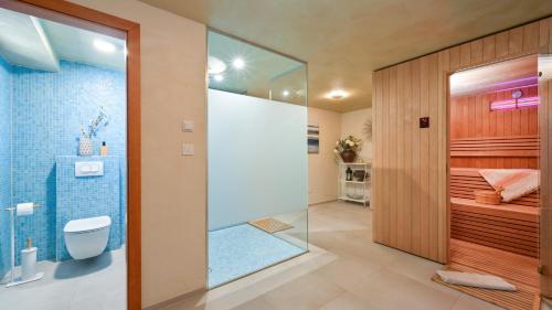 a bathroom with a shower with a glass door at Villa Pine Log by Villas Guide in Dubrovčan
