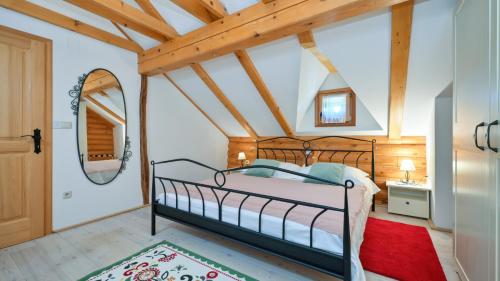 a bedroom with a bed in a room with wooden ceilings at Villa Pine Log by Villas Guide in Dubrovčan