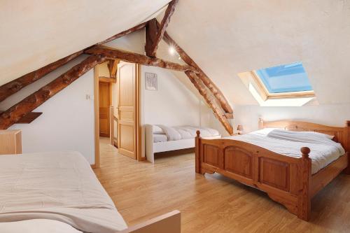 a attic bedroom with two beds and a skylight at La Mailleraie - Le Moulin in Valojoulx