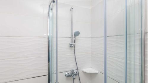 a shower with a glass door next to a toilet at Villa Isabella by Villas Guide in Malinska