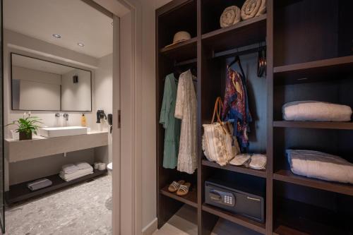 a bathroom with a sink and a mirror at Oya Beach Resort in Hersonissos