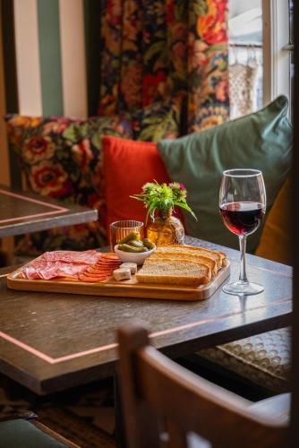a table with a plate of food and a glass of wine at The Market Tavern in Bampton