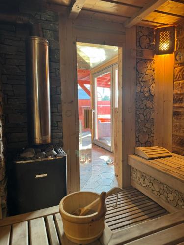 a kitchen with a stove and a tub in a room at Třebovický mlýn in Ostrava