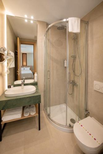 a bathroom with a shower and a sink and a toilet at Arkk Rooms in Antalya