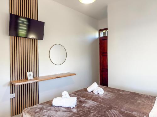 a bedroom with a bed with two towels on it at Villa Kalliopi in Gerakini