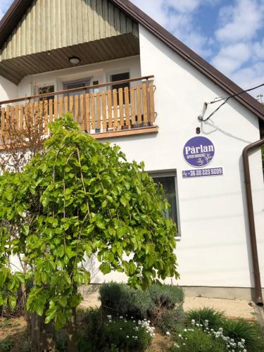 a tree in front of a building with a balcony at Pärlan 1 in Balatonboglár