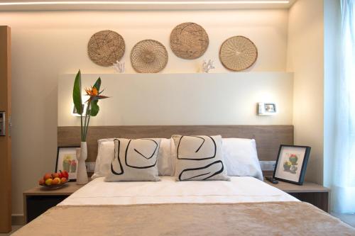 a bedroom with a bed with hats on the wall at Luz House Marbella Hostal in Marbella