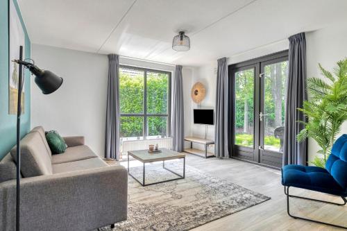a living room with a couch and a table at 6 - Person Forest 183 Bungalow in Ewijk