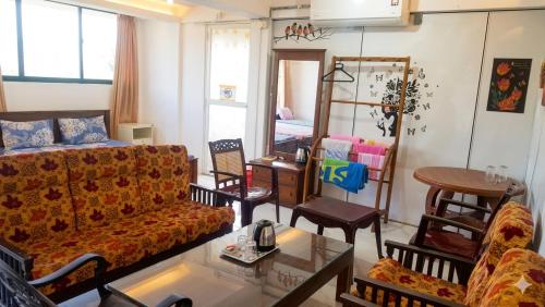 a living room with a couch and a table at The Beehive in Bambalapitiya