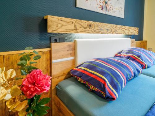a bed with two pillows and a flower on it at Landler Auszeit in Thiersee
