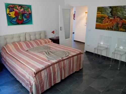 a bedroom with a bed and two stools at Guest House Soma Montecchio in Montecchio Emilia