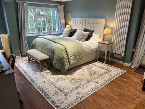 a bedroom with a bed and a chair and a window at Heydon Private Guest Suite Self Check-in & Parking in Heydon