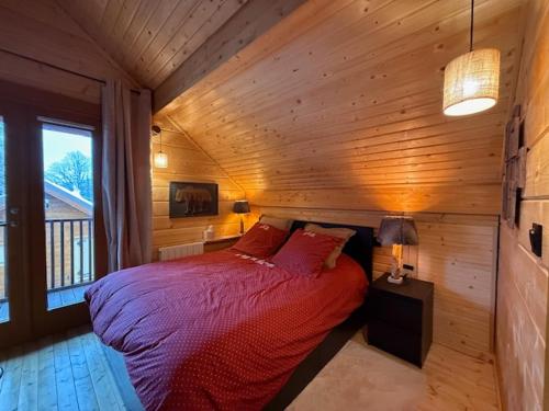 a bedroom with a bed in a wooden room at Résidences de Mélisa La Foux d'Allos in La Foux d'Allos