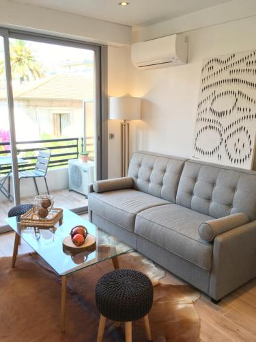 a living room with a couch and a table at STUDIO by the croisette in Cannes